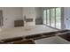 Bright living room with fireplace, gray cabinets, and sliding glass doors to deck at 395 Meadow Walk Dr, Fuquay Varina, NC 27526