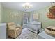 Green Bedroom with a crib, recliner, natural accents, and patterned rug at 406 Applecross Dr, Cary, NC 27511