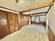 Bedroom featuring wood accents, carpeted floors, and built in closet at 4100 Durham Rd, Raleigh, NC 27614