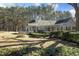 Inviting home showcasing a cozy porch and surrounded by lush greenery at 4100 Durham Rd, Raleigh, NC 27614