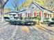 Charming one-story home featuring red window shutters, mature landscaping, and a cozy covered porch at 4100 Durham Rd, Raleigh, NC 27614