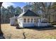 Rear exterior view highlighting the sunroom and well-kept lawn at 4100 Durham Rd, Raleigh, NC 27614