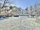 Backyard view of home featuring sunroom and mature landscaping at 4100 Durham Rd, Raleigh, NC 27614