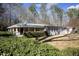 Charming exterior showcasing a wraparound porch and well-maintained landscaping at 4100 Durham Rd, Raleigh, NC 27614