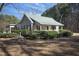 Beautiful cottage-style home with a quaint front porch and lush landscaping at 4100 Durham Rd, Raleigh, NC 27614