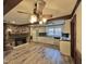 Open-concept kitchen with stone fireplace, tile floors, and white appliances at 4100 Durham Rd, Raleigh, NC 27614