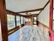Bright living room featuring wood beams, wood floors, and lots of natural light at 4100 Durham Rd, Raleigh, NC 27614