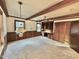 Spacious living room with exposed beams, wood paneling, and a large window at 4100 Durham Rd, Raleigh, NC 27614