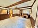 Spacious living room with carpet, wood beams, and a vintage desk at 4100 Durham Rd, Raleigh, NC 27614