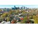 Aerial view of a neighborhood with the home indicated, set against a cityscape backdrop at 518 Worth St, Raleigh, NC 27601
