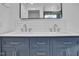 Stylish bathroom featuring a double vanity with blue cabinetry and modern fixtures at 518 Worth St, Raleigh, NC 27601