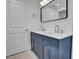 Elegant bathroom featuring a double vanity with white countertops and blue cabinetry at 518 Worth St, Raleigh, NC 27601