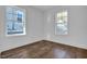 Bright bedroom with hardwood floors and natural light streaming through two large windows, creating a welcoming atmosphere at 518 Worth St, Raleigh, NC 27601