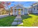Charming blue home with a bright yellow front door and a walkway leading to the porch at 518 Worth St, Raleigh, NC 27601