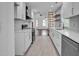 Open-concept kitchen with stainless steel appliances, white cabinets, and seamless flow to the living area at 518 Worth St, Raleigh, NC 27601
