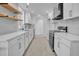 Modern kitchen featuring white cabinets, stainless steel appliances, and sleek countertops at 518 Worth St, Raleigh, NC 27601