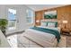 Sunlit main bedroom with modern decor, wood paneling, and access to a private outdoor deck at 518 Worth St, Raleigh, NC 27601