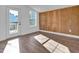 Bright sunroom with wood paneling, hardwood floors, and access to an outdoor deck at 518 Worth St, Raleigh, NC 27601