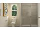 Cozy bathroom with modern toilet, shower with glass door, and natural light, providing a relaxing space at 532 Morning Light Dr, Angier, NC 27501