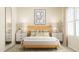 Cozy bedroom with a wooden bed, neutral decor, and bedside tables with lamps at 532 Morning Light Dr, Angier, NC 27501
