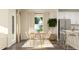 Bright dining area with a wooden table and white chairs, open to the kitchen at 532 Morning Light Dr, Angier, NC 27501