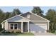 Charming single-story home with gray siding, white trim, covered entry, and attached two-car garage at 532 Morning Light Dr, Angier, NC 27501