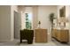 Well-lit home office with a wooden desk, green chair, and view to a window at 532 Morning Light Dr, Angier, NC 27501