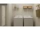 Functional laundry room with washer, dryer, and storage shelves, providing convenience and organization at 532 Morning Light Dr, Angier, NC 27501