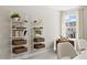 Bright home office with stylish shelving, comfortable seating, and a large window providing natural light at 6132 Arsenal Ave, Raleigh, NC 27610