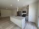 Bright kitchen features stainless appliances, granite countertops, gray cabinets, and wood-look flooring at 6132 Arsenal Ave, Raleigh, NC 27610
