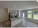 Bright kitchen features stainless appliances, granite countertops, gray cabinets, and wood-look flooring at 6132 Arsenal Ave, Raleigh, NC 27610