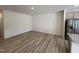 Spacious living room with wood-look flooring, ample natural light and neutral color palette at 6132 Arsenal Ave, Raleigh, NC 27610