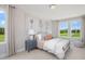 Relaxing bedroom with great natural light, soft textures, and views of the beautiful green outdoors at 6134 Arsenal Ave, Raleigh, NC 27610