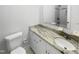 A clean and modern bathroom featuring a marble countertop and a tiled shower at 6423 Whitt Rd, Durham, NC 27712