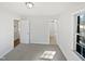 This bedroom features neutral carpet, white trim, and two windows allowing for natural light at 6423 Whitt Rd, Durham, NC 27712