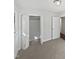 This bedroom features neutral carpet, white trim, and closet at 6423 Whitt Rd, Durham, NC 27712