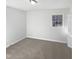 Cozy bedroom with neutral carpet, white trim, and one window allowing for natural light at 6423 Whitt Rd, Durham, NC 27712