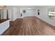 This spacious living room boasts a fireplace, large windows, and laminate flooring at 6423 Whitt Rd, Durham, NC 27712