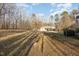 Expansive backyard featuring a detached garage with carport, offering ample space and functionality on a sunny day at 69 Holly Tree Dr, Timberlake, NC 27583