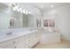 Bathroom featuring a double sink vanity, jacuzzi tub, and large windows at 69 Holly Tree Dr, Timberlake, NC 27583