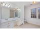 Bathroom featuring a double sink vanity and large windows, providing ample natural light at 69 Holly Tree Dr, Timberlake, NC 27583