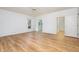 Spacious bedroom featuring hardwood floors, large windows, and a view into the bathroom at 69 Holly Tree Dr, Timberlake, NC 27583