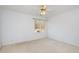 Carpeted bedroom featuring a ceiling fan and large window providing ample natural light at 69 Holly Tree Dr, Timberlake, NC 27583