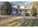 Inviting two-story home featuring a classic covered porch and mature landscaping at 69 Holly Tree Dr, Timberlake, NC 27583