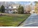 Charming two-story home with a welcoming front porch and a long driveway leading to a detached garage at 69 Holly Tree Dr, Timberlake, NC 27583