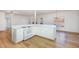 Bright kitchen with white cabinetry, hardwood floors, and a functional layout at 69 Holly Tree Dr, Timberlake, NC 27583