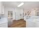 Well-lit kitchen with white cabinets and hardwood floors, creating a clean and inviting space at 69 Holly Tree Dr, Timberlake, NC 27583