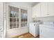 Bright laundry room featuring a large window and modern washer and dryer at 69 Holly Tree Dr, Timberlake, NC 27583