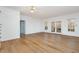 Open living room with hardwood floors, white walls, and french doors at 69 Holly Tree Dr, Timberlake, NC 27583