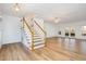 Spacious living room with hardwood floors, staircase, and plenty of natural light at 69 Holly Tree Dr, Timberlake, NC 27583